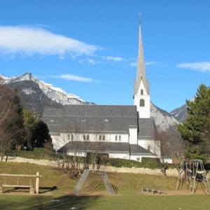 An image showing a church with a playset in the foreground.