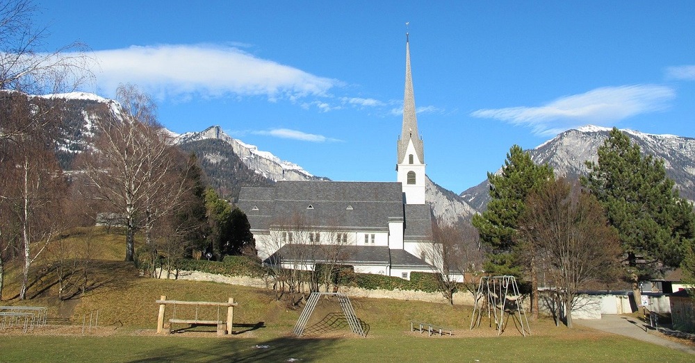 An image showing a church with a playset in the foreground.