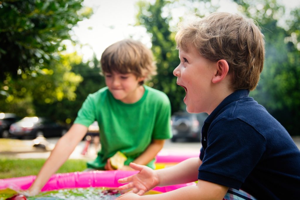 An image showing two children playing outside.