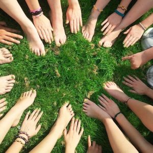 An image with a bunch of children showing off their nail polish.