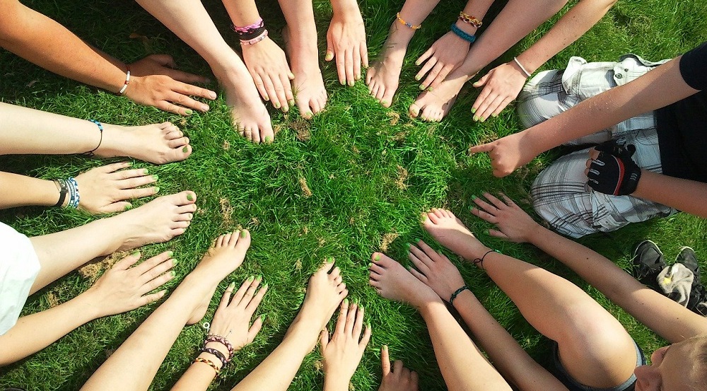 An image with a bunch of children showing off their nail polish.