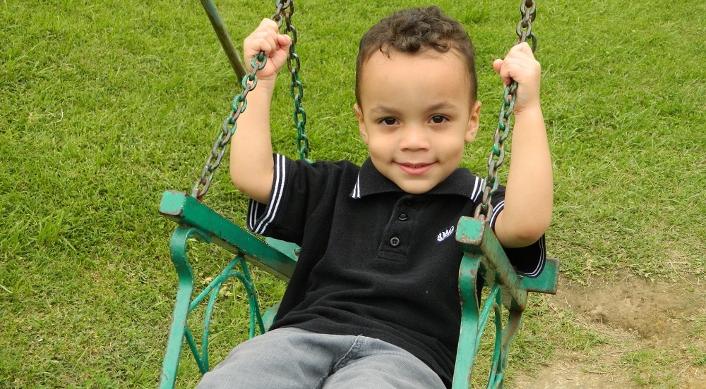 An image of a child using a chair style swing seat.