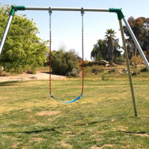 An image showing a blue swing seat attached to a swing set.