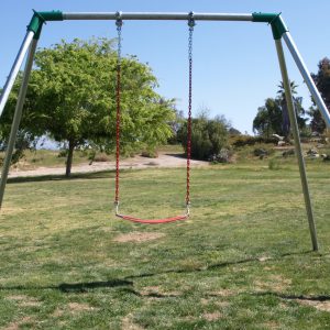 An image of a red swing seat attached to a swing set.