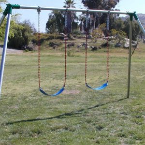 An image showing 2 blue swing seats attached to a swing set.