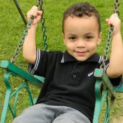 An image of a child using a chair style swing seat.